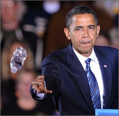 Democratic presidential candidate Sen. Barack Obama, D-Ill., throws a bottle of water to a supporter in the crowd who had passed out during a rally at Wicker Memorial Park in Highland Ind., Friday, Oct. 31, 2008.(AP Photo/Paul Beaty)
